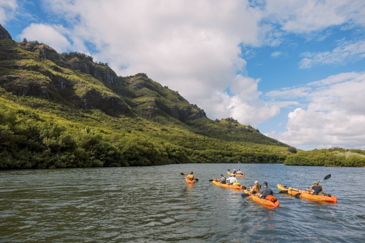 Guided kayak tour on the Huleʻia River with views of the Haʻupu Mountain Range on Kauaʻi