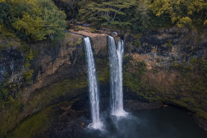 a large waterfall over some water