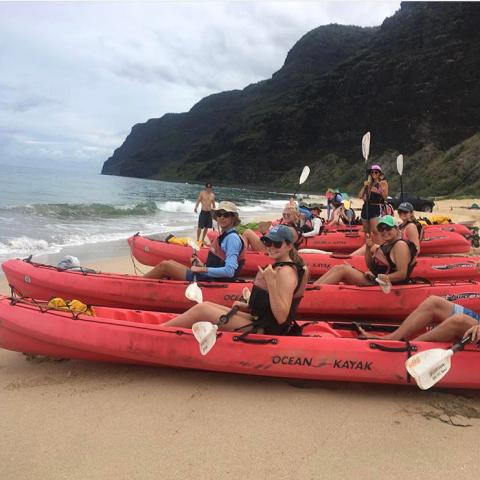 group on kayaks on shore