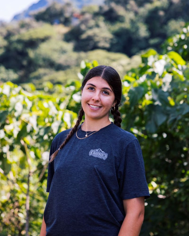 Guide at Outfitters Kauai smiling during a rainforest adventure tour, showcasing expert local leadership on Kauai zipline and kayaking excursions