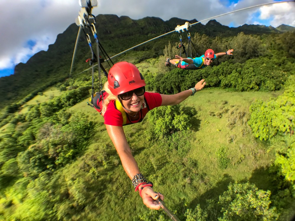 Superman-style zipline on Kauaʻi at Kīpū Ranch, guests flying above lush green valleys on the Nui Kauaʻi Zipline